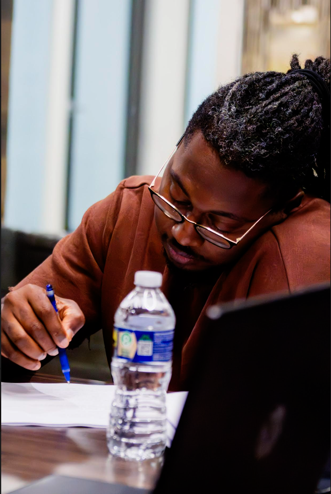 Crew member taking notes during a Park Dreams production meeting